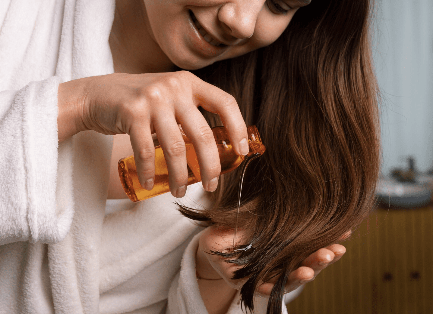 woman applying nourishing hair oil