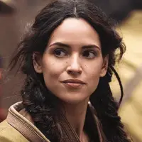 Adria Arjona as Bix Caleen with braided hair and a work uniform