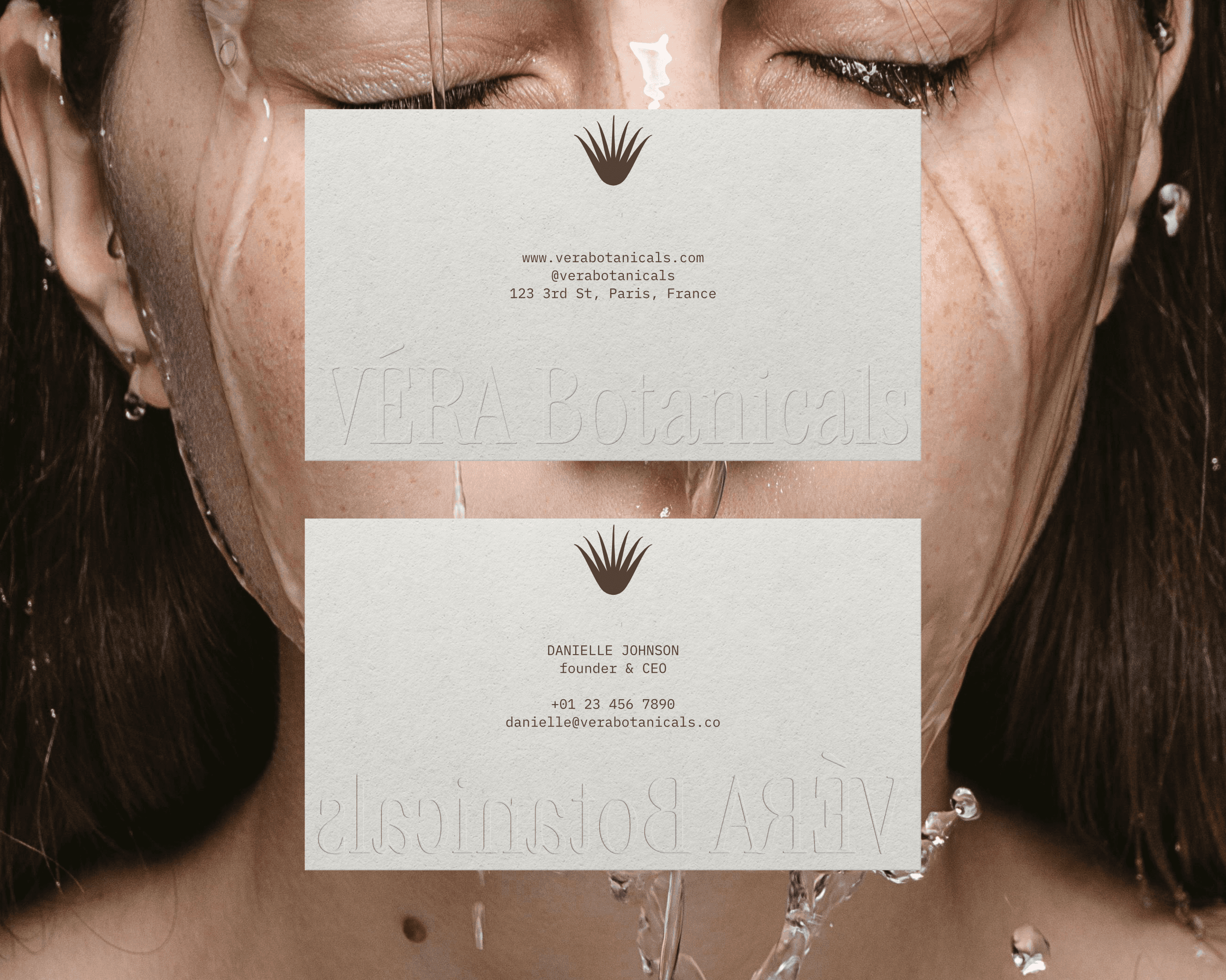 The VÉRA Botanicals business card design, which features the brand logo embossed on the bottom with company and employee details printed in the center of the card.