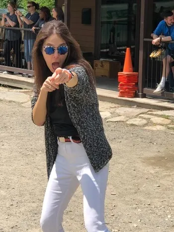 Stephanie Moss pointing at the camera at Camp Lenox
