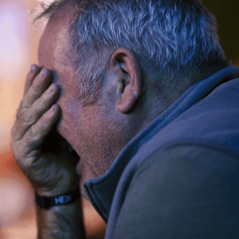 Gentleman with hand in his palm laughing at a St Pete Standup show