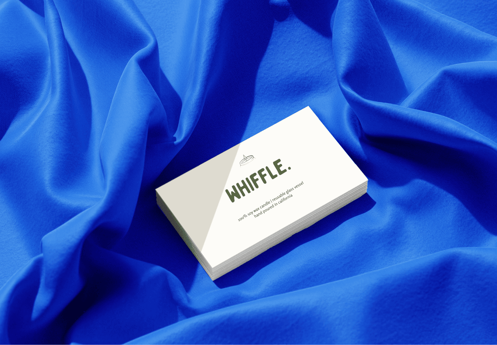 Business Card for Whiffle sitting on blue velvet material