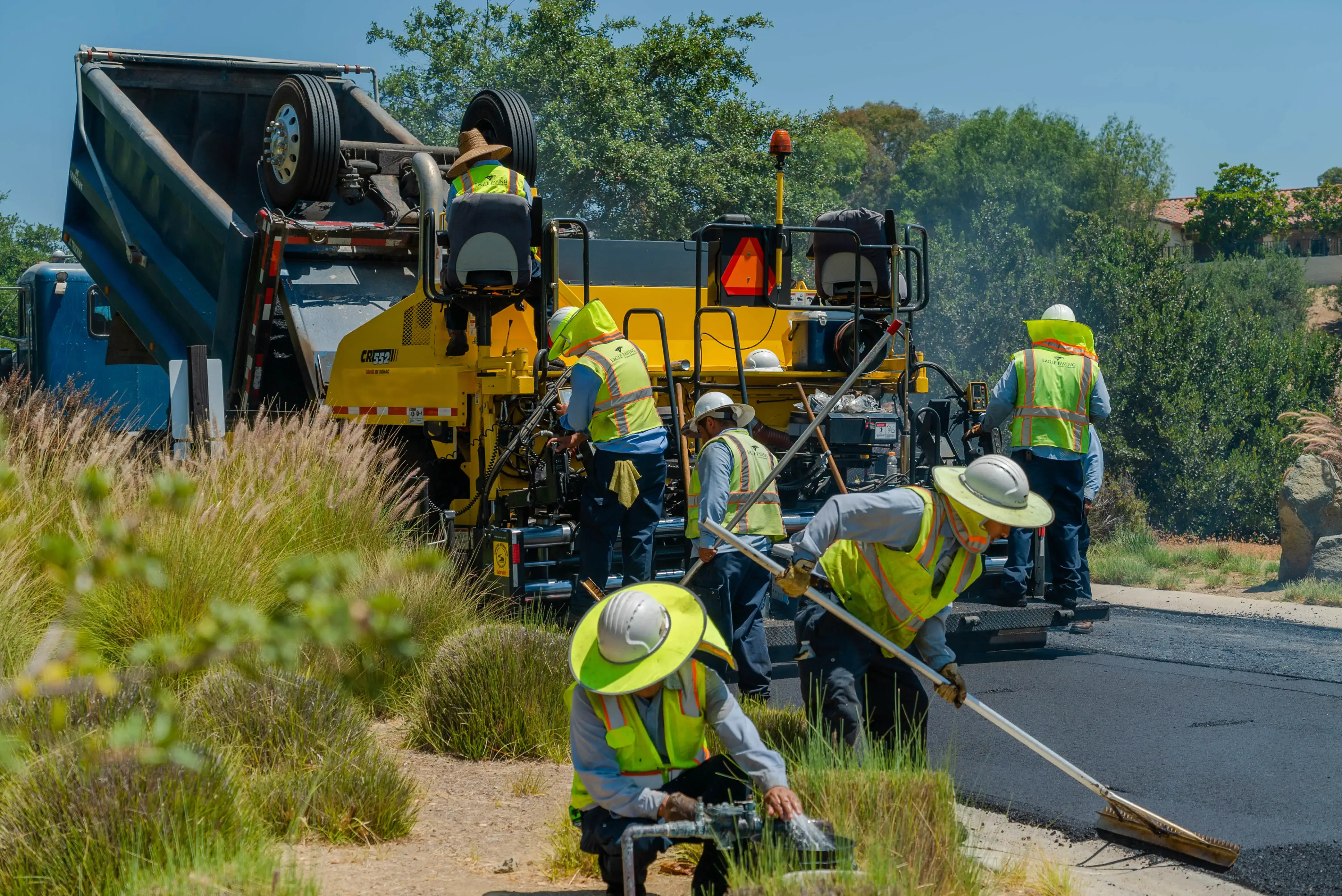 Asphalt paving crew on paving machine on project