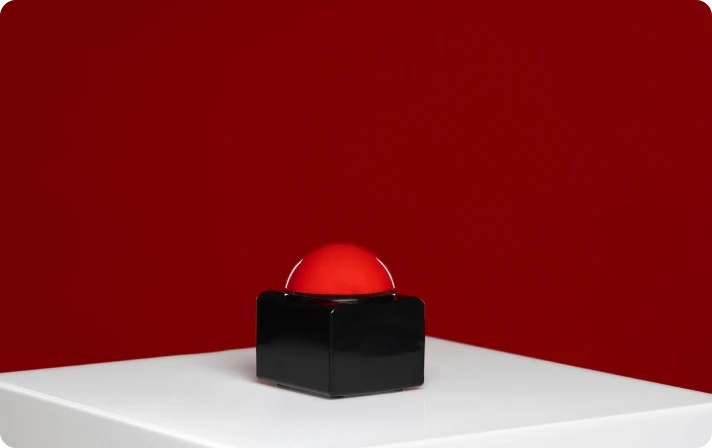 Red buzzer on white table