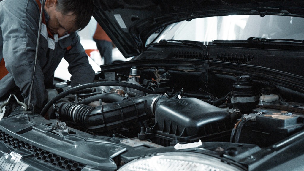Man looking at car engine