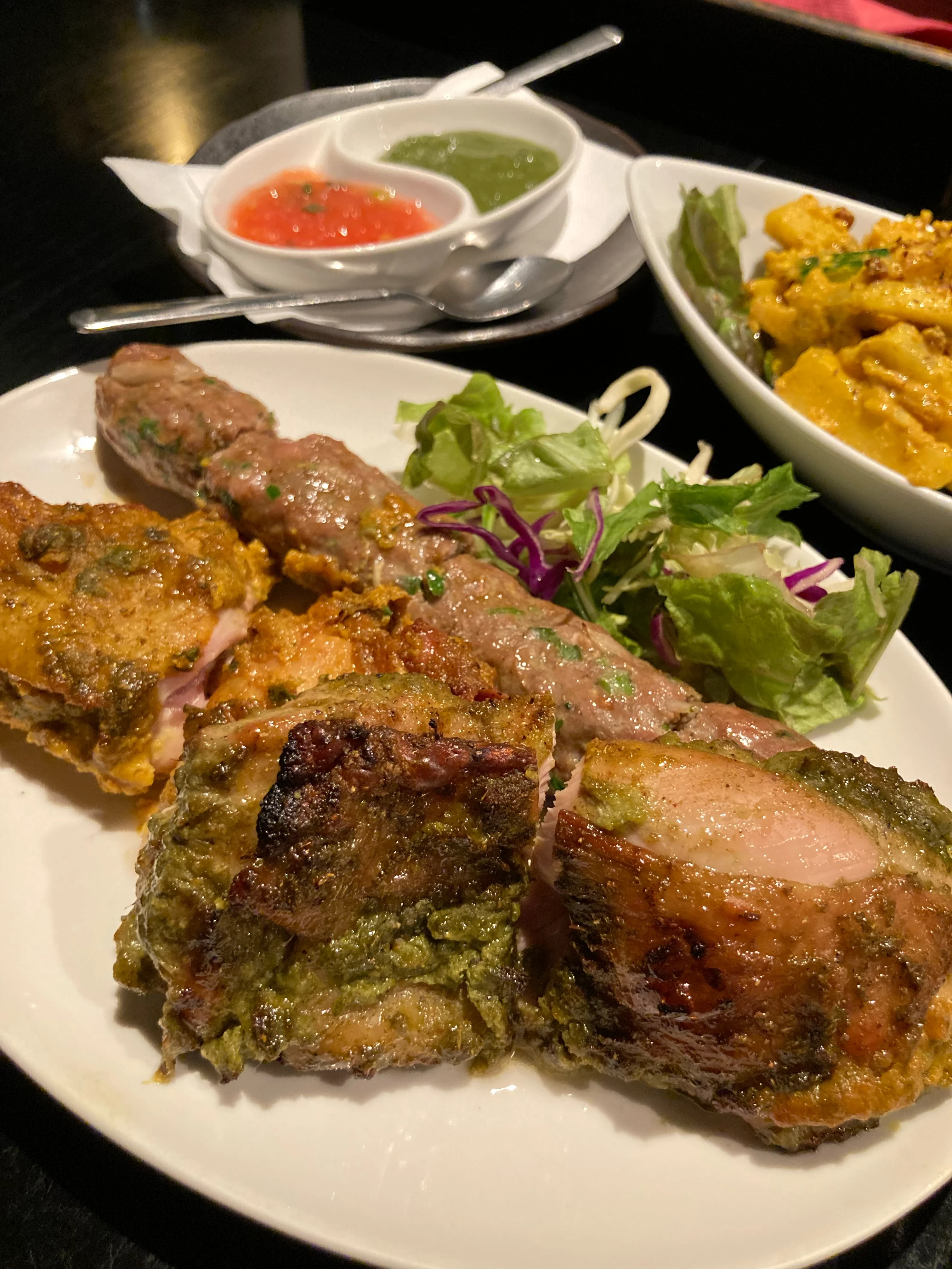 a plate of andoori trinity' – basil chicken, chicken tikka, and shish kebab