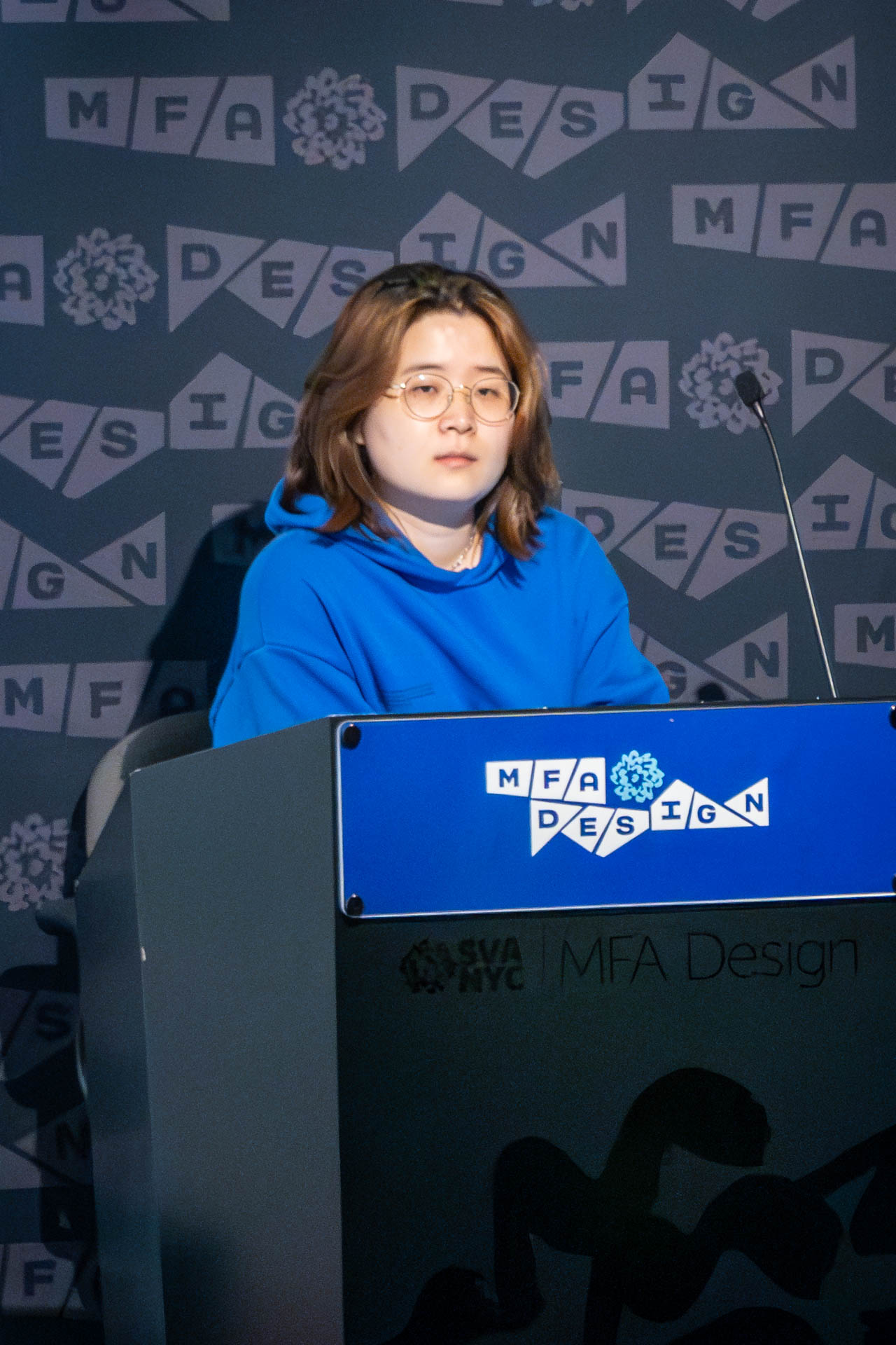 student at a podium giving a presentation