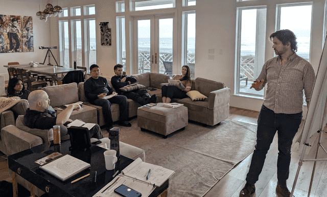 Group sitting performing team building excersise
