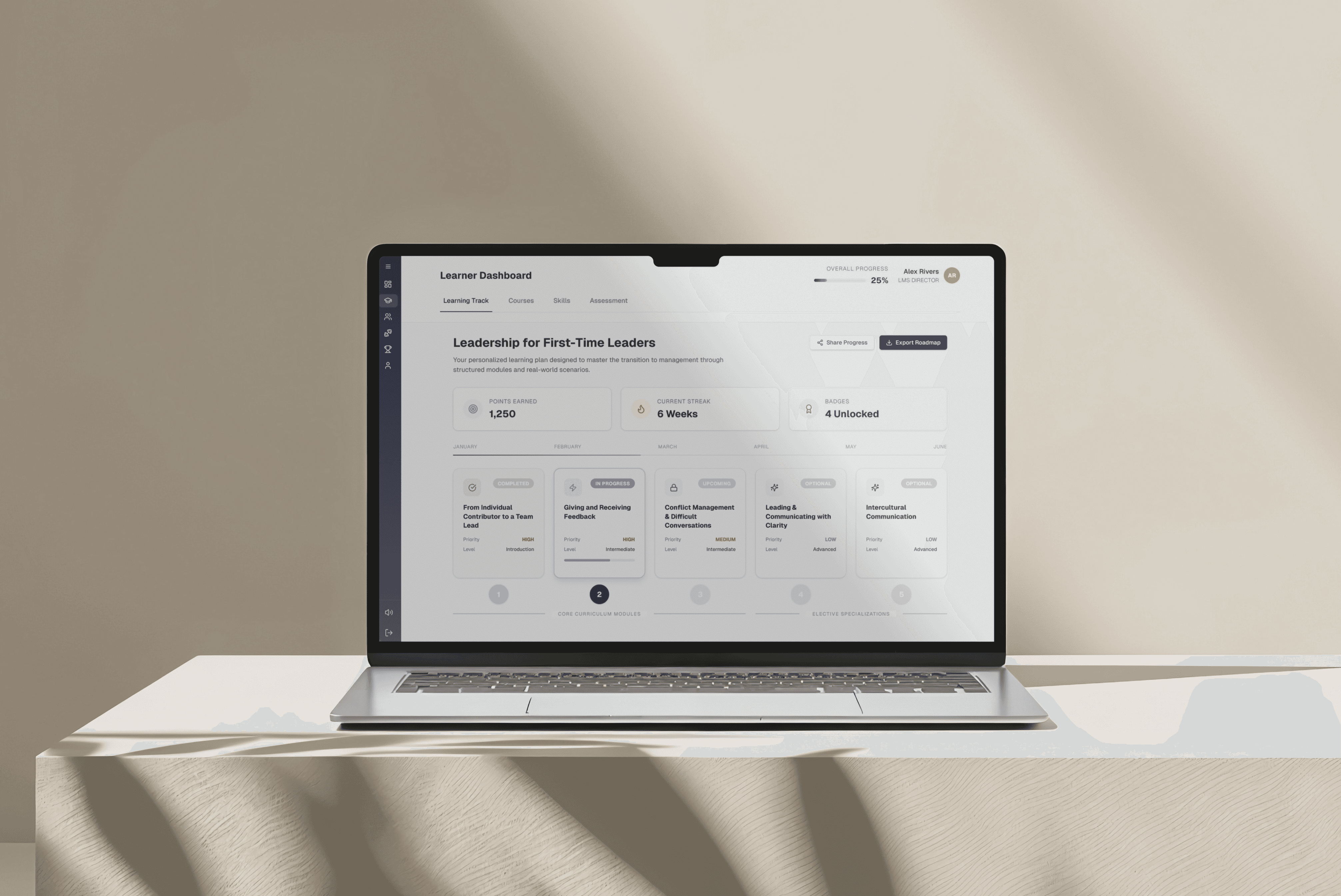 Laptop on a table displaying the Allie learning platform dashboard with training progress and course library