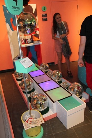 overview image of an exhibition and two people taking