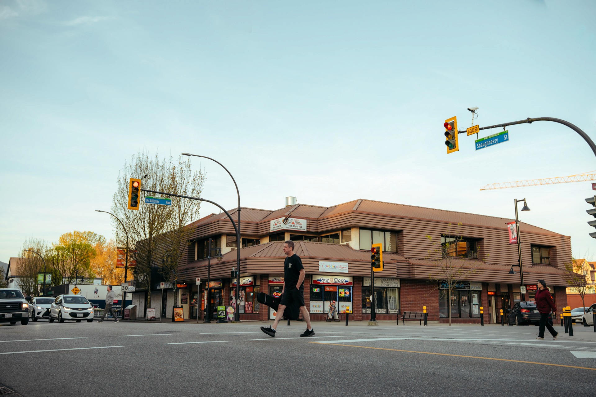 An older male basketball player with grey hair, wearing a blue jersey (number 29), running down the court during an indoor game.
