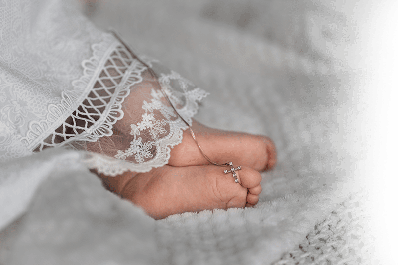 Babies feet and cross