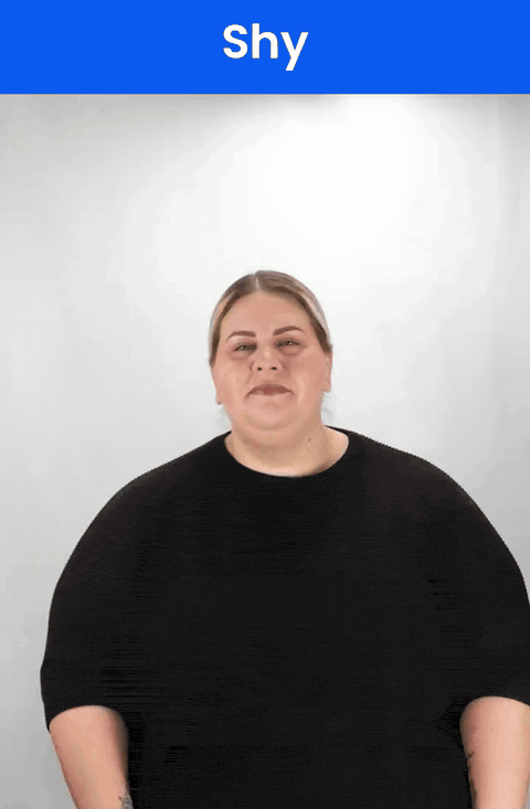 Animated GIF: a Deaf signer signs SHY in ASL, the backs of bent fingers twisting once against the cheek.