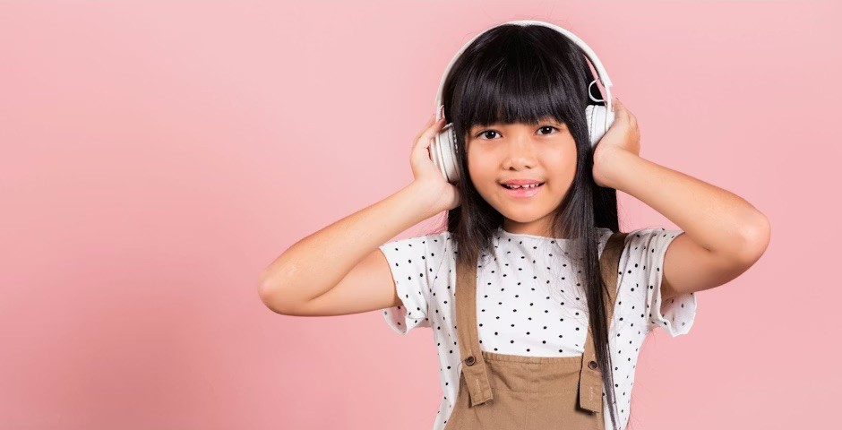 Girl with headphones listening to a podcast