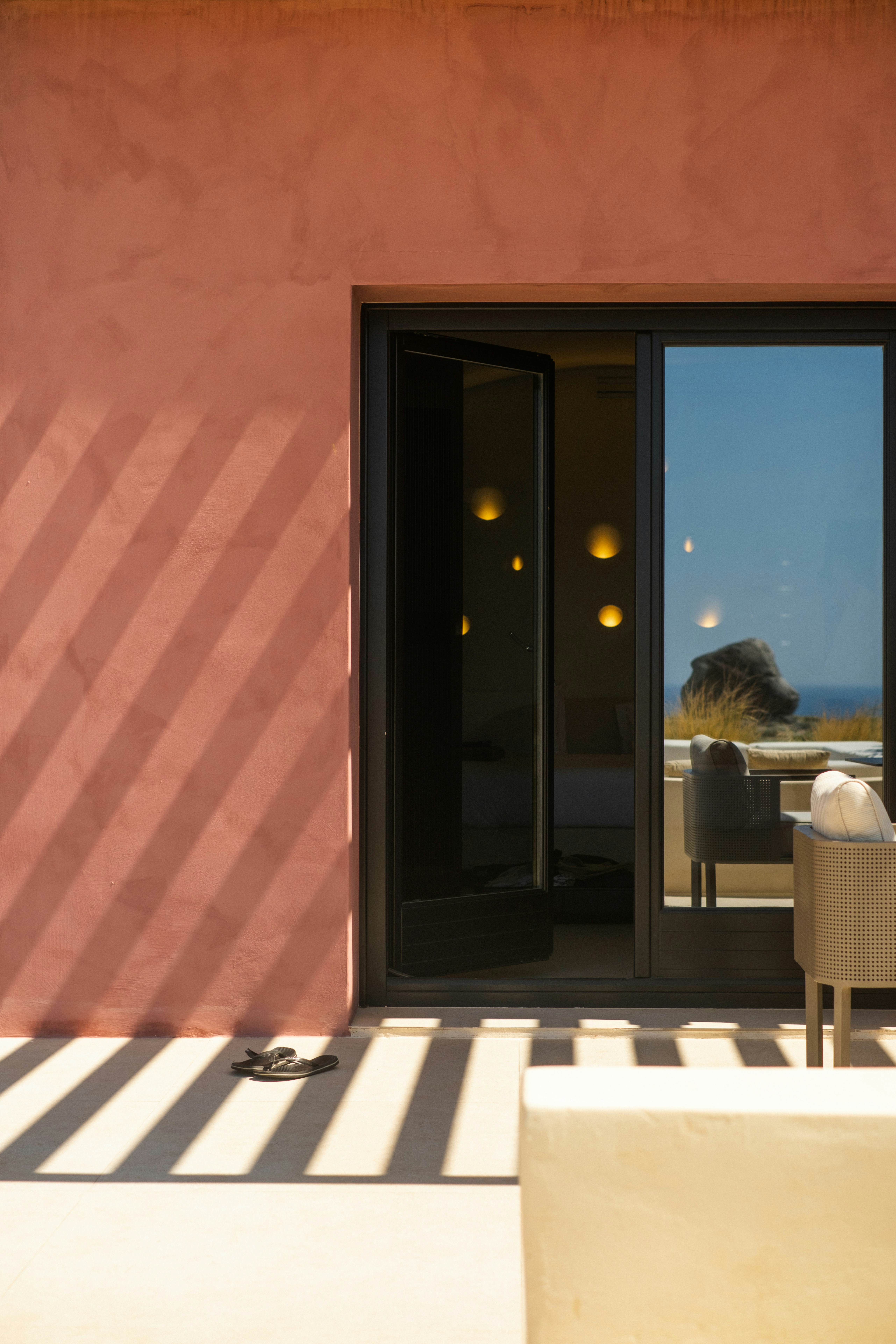 Warm minimalist café with curved walls and stools.