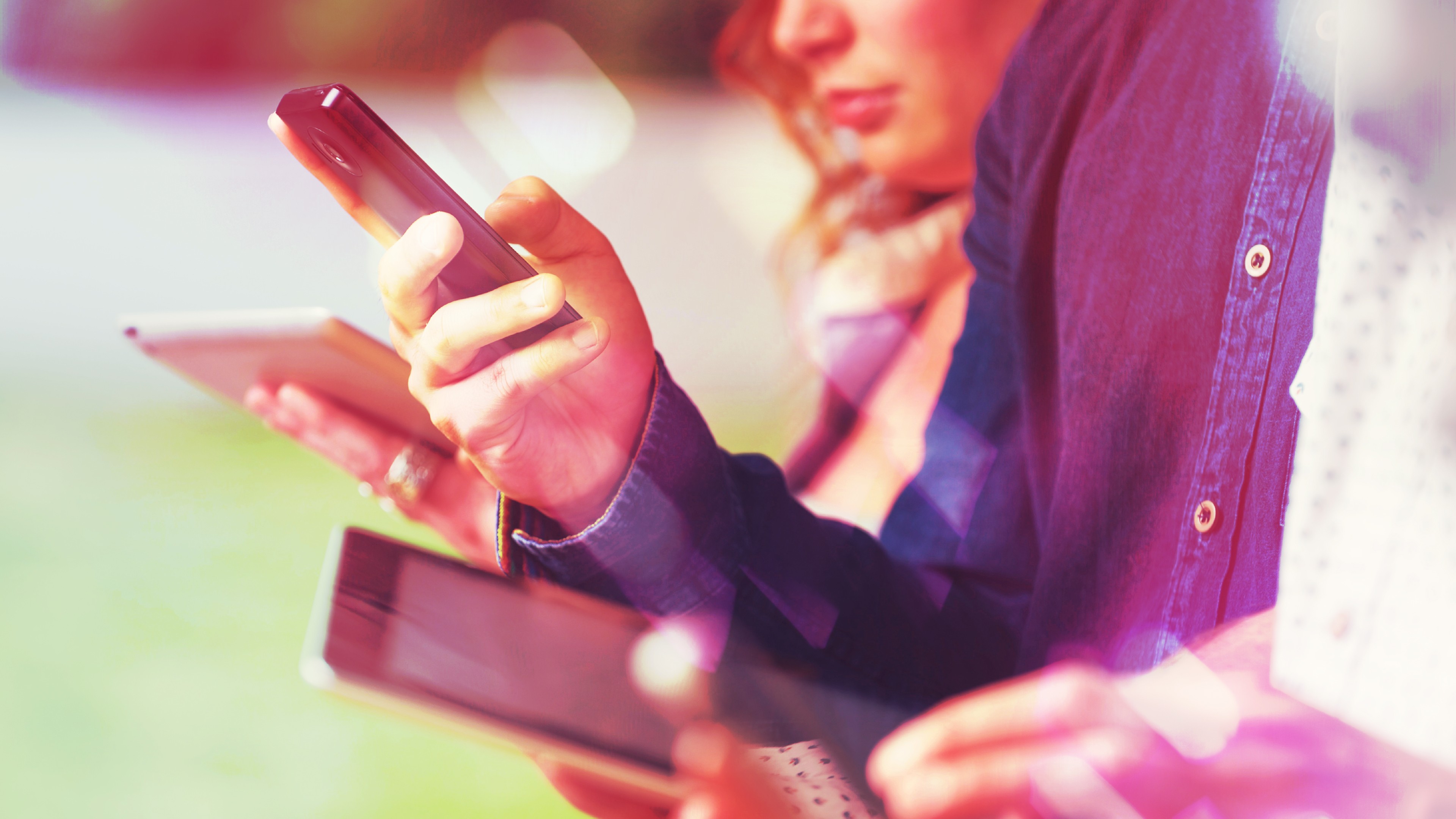 A group of people looking at mobile phones and tablets