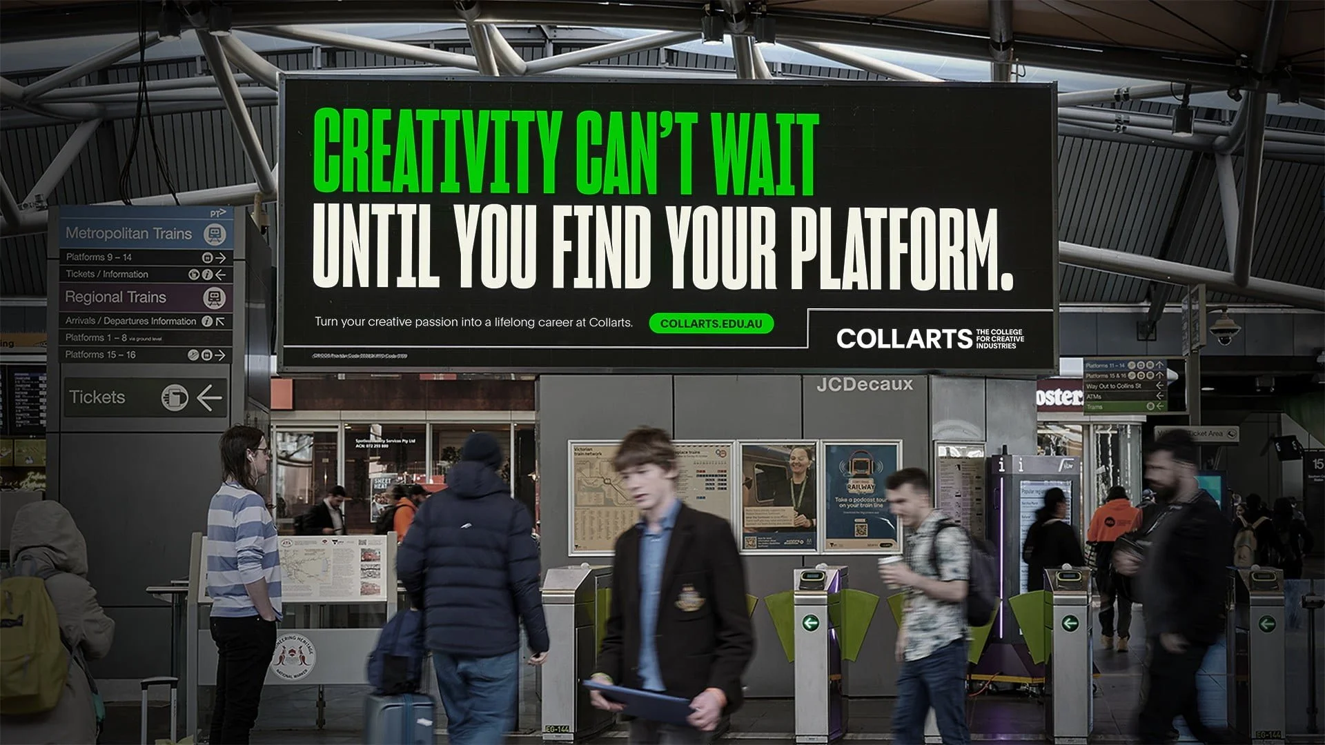 Train station billboard for Collarts: 'Creativity can't wait until you find your platform.' with commuters at ticket gates
