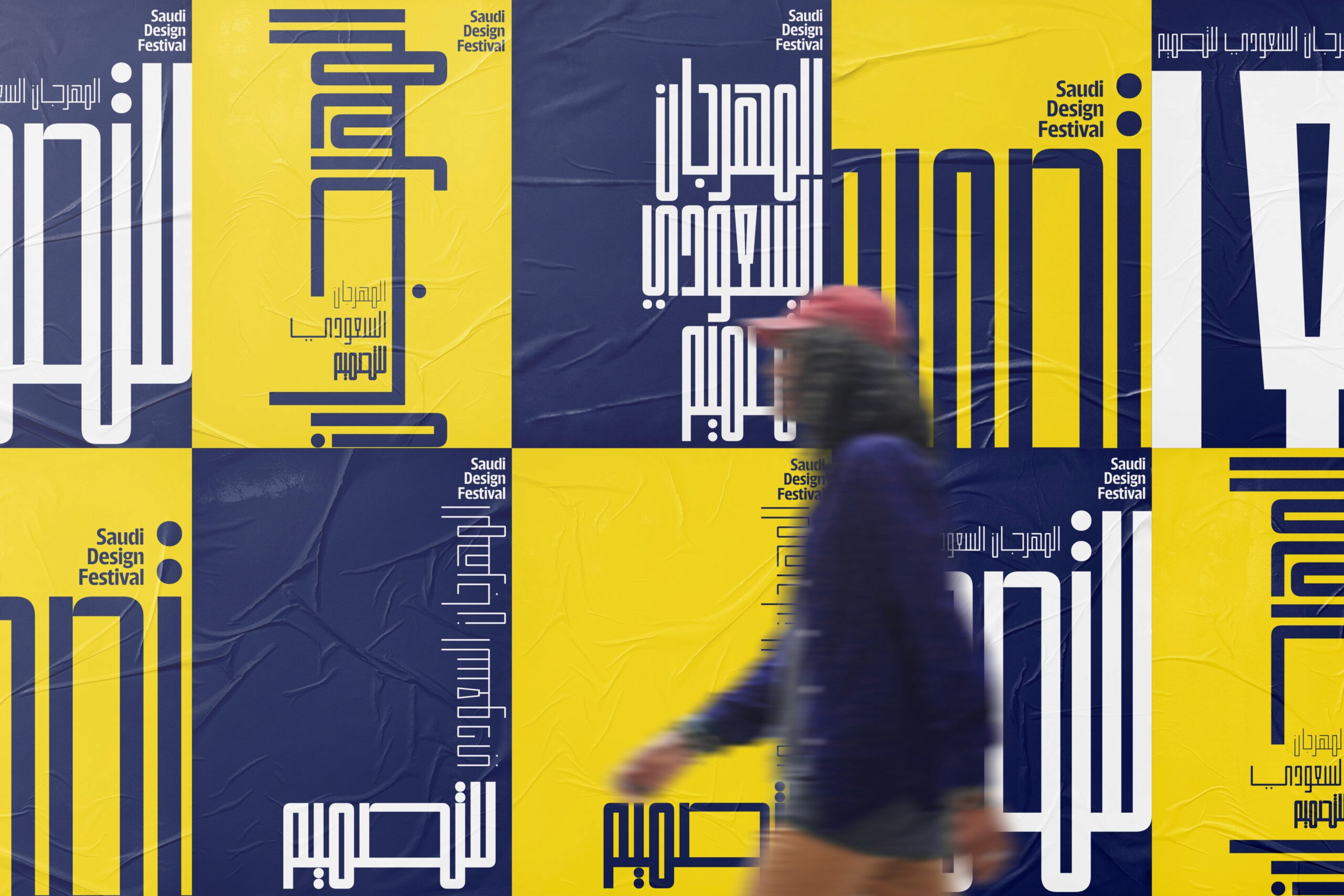 poster wall with person walking in front