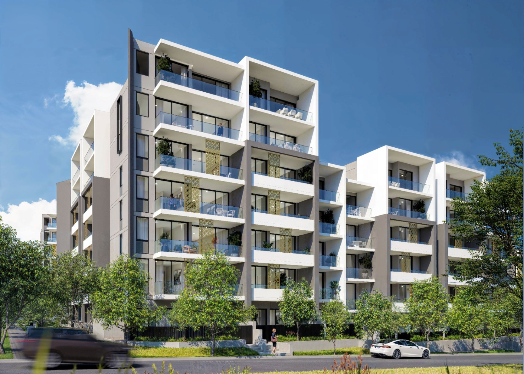 Modern mid-rise apartment buildings at Kew Tallawong featuring wide balconies, contemporary architecture, and landscaped street frontage under a clear blue sky.