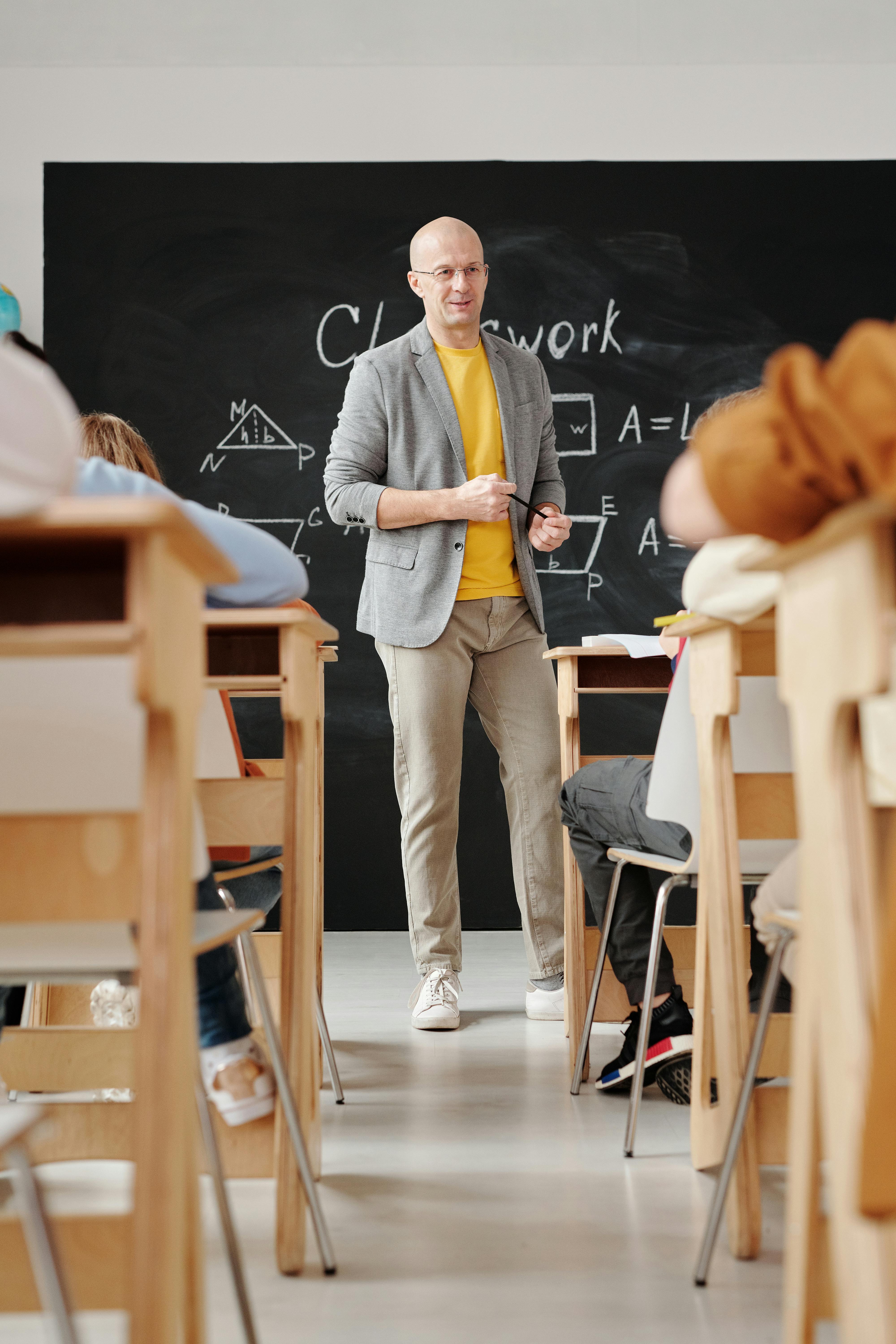 Teacher Standing in Front of a Blackboard