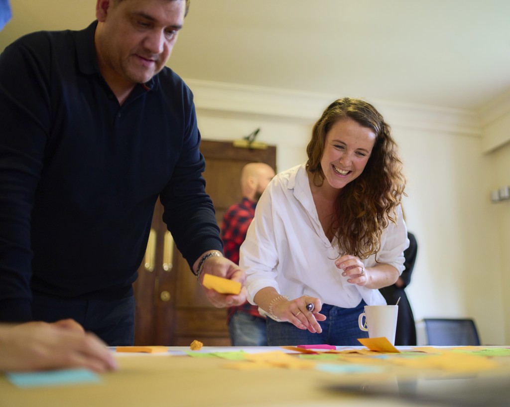 Photo of two team members brainstorming and smiling