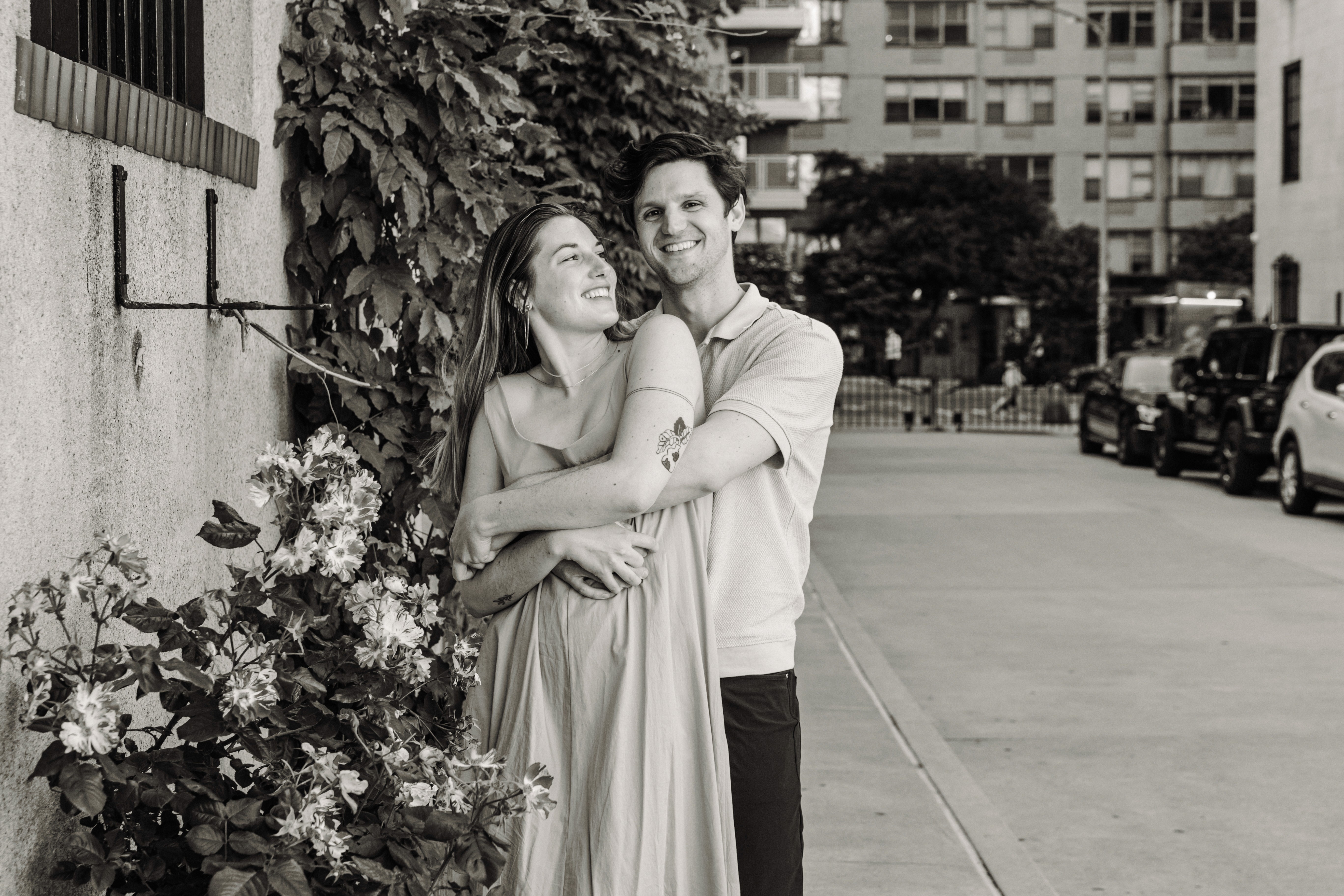 6:13 PMNewly engaged couple sitting on a stoop in the West Village, NYC bathed in warm golden hour light — romantic, candid golden hour engagement photography by Lizz Spano Photography, New York City engagement photographer.