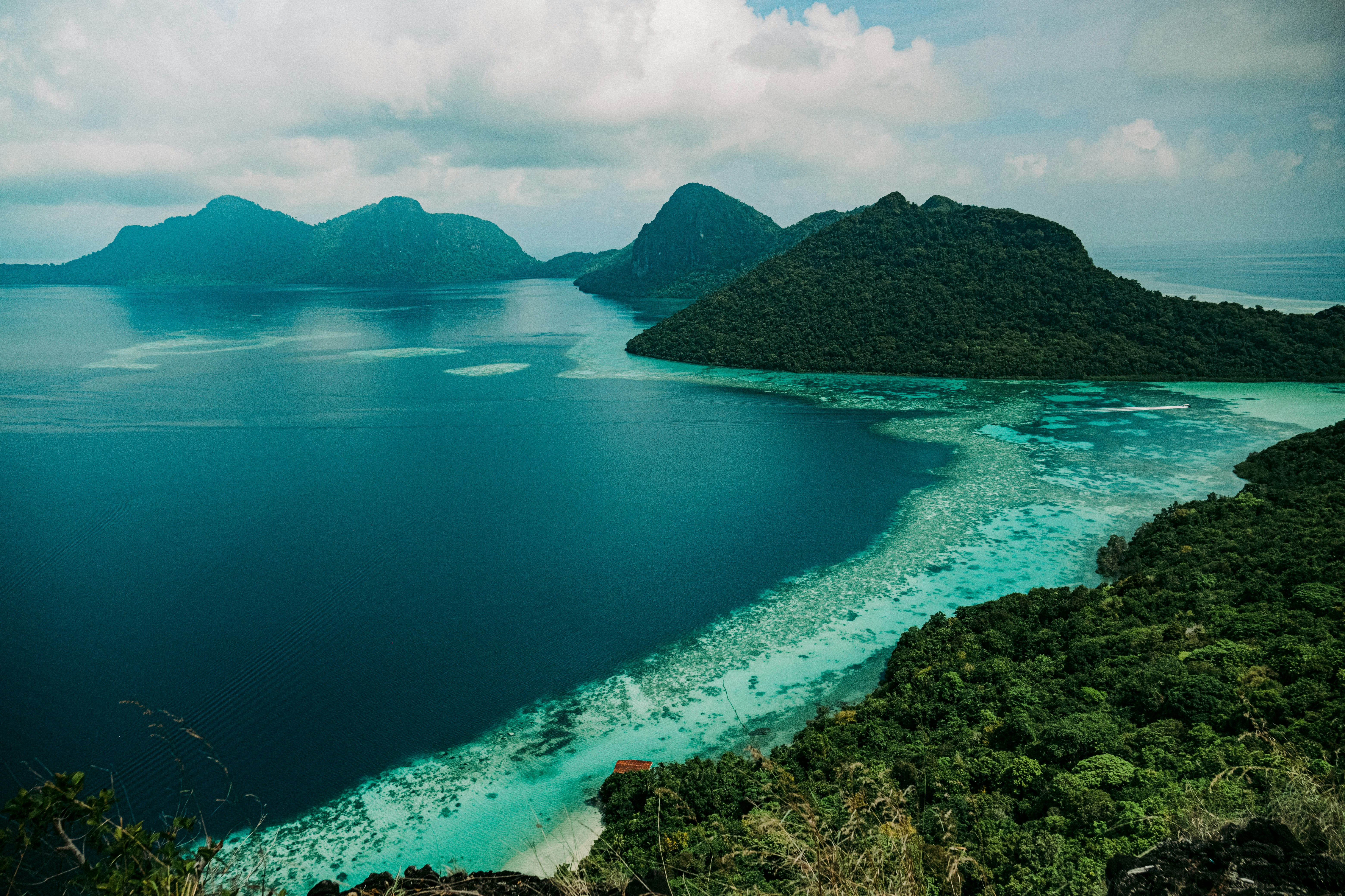 an aerial view of a tropical island in the middle of the ocean