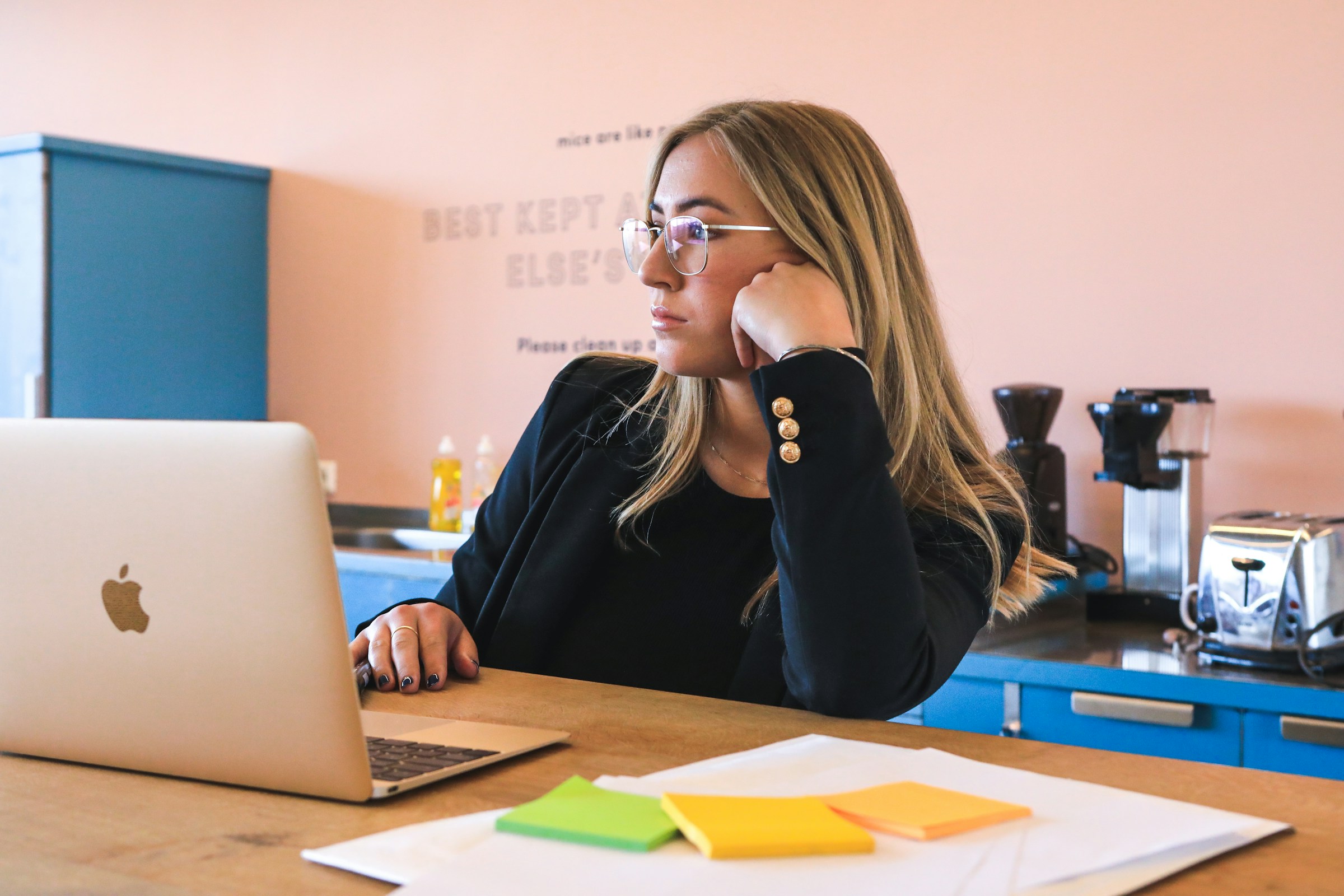 person in office looking at her essay - How To Cite AI In MLA