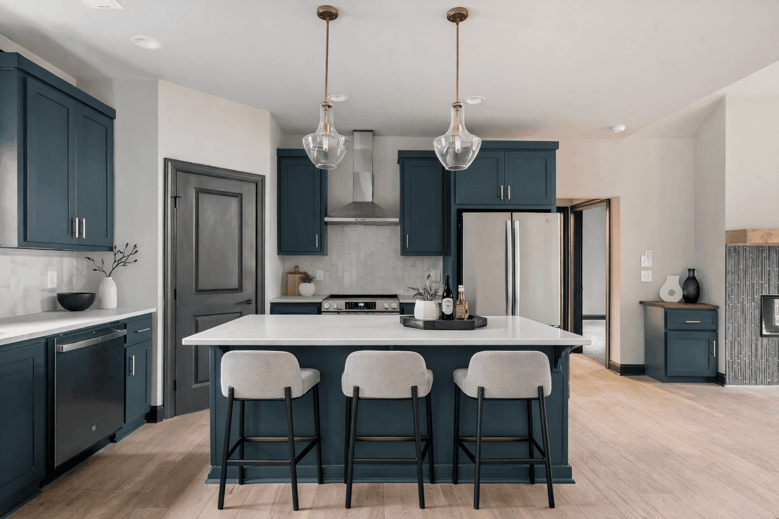 Open concept kitchen and living room with vaulted ceilings and hardwood floors