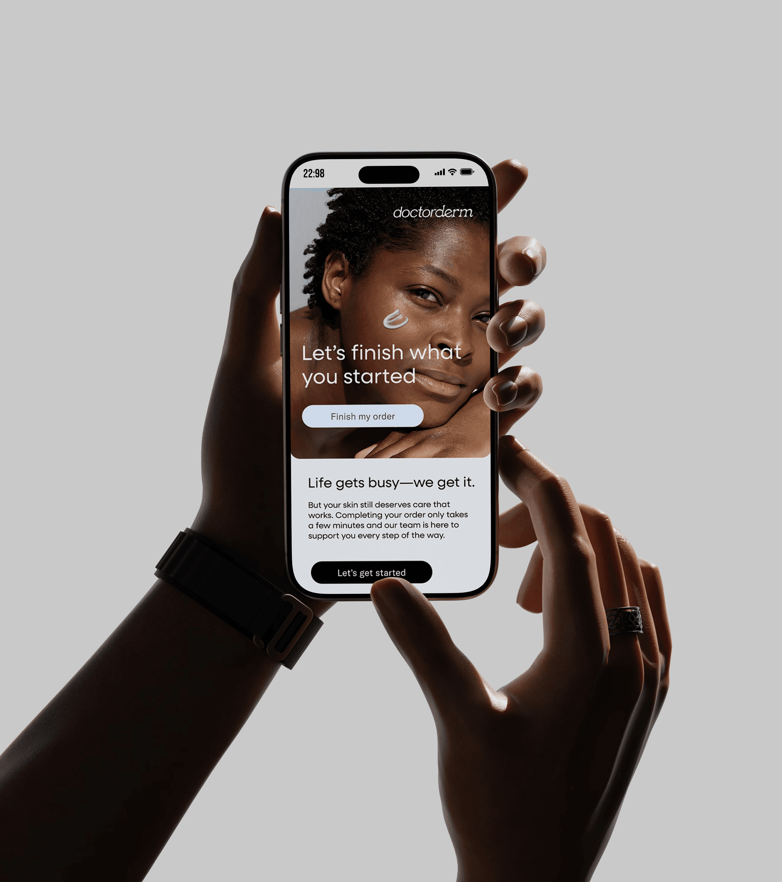 Hands holding a smartphone showing the Doctorderm skincare email.