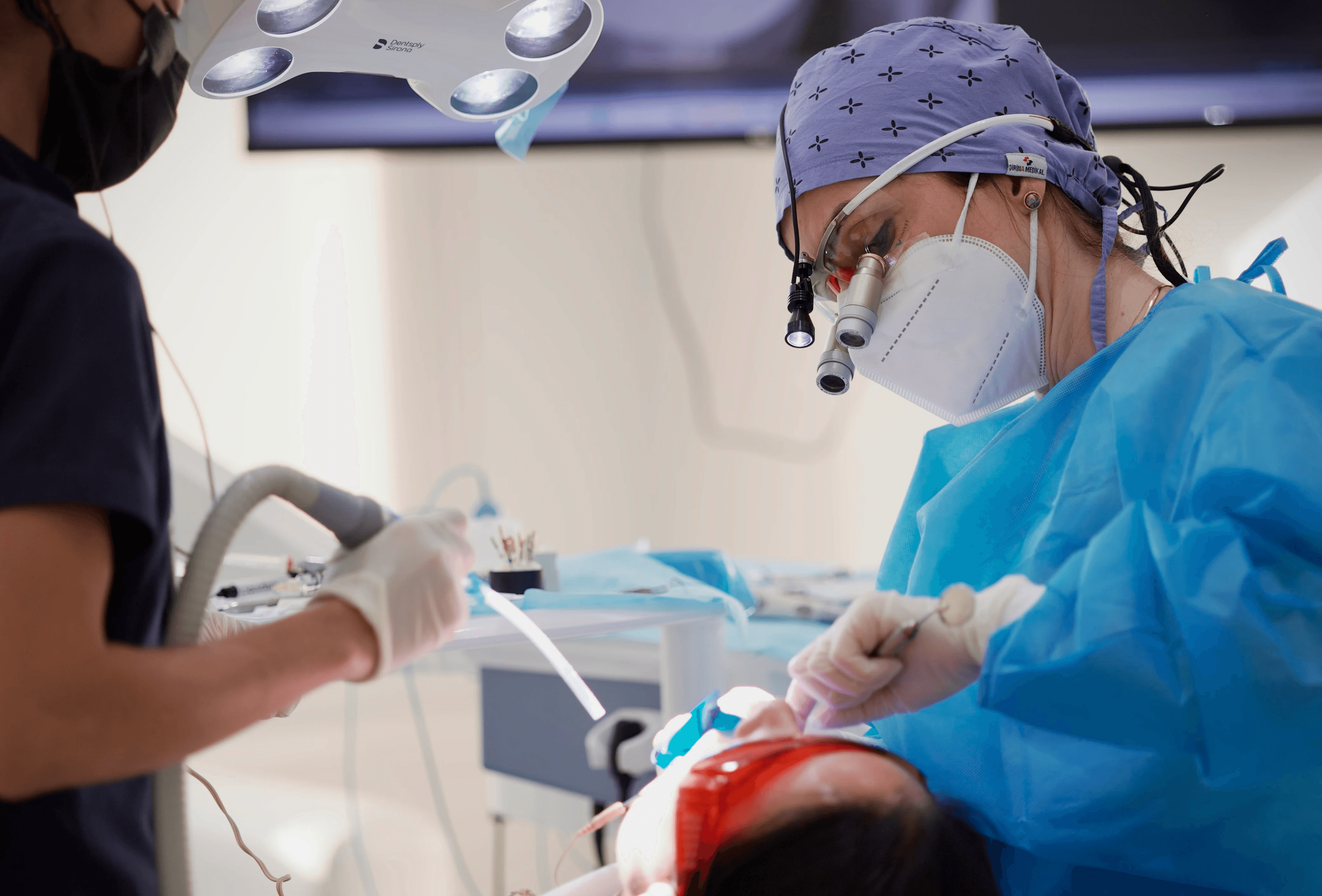 An expert dentist inspecting a patient’s jaw while discussing can ear wax cause jaw pain by Invisalign Center