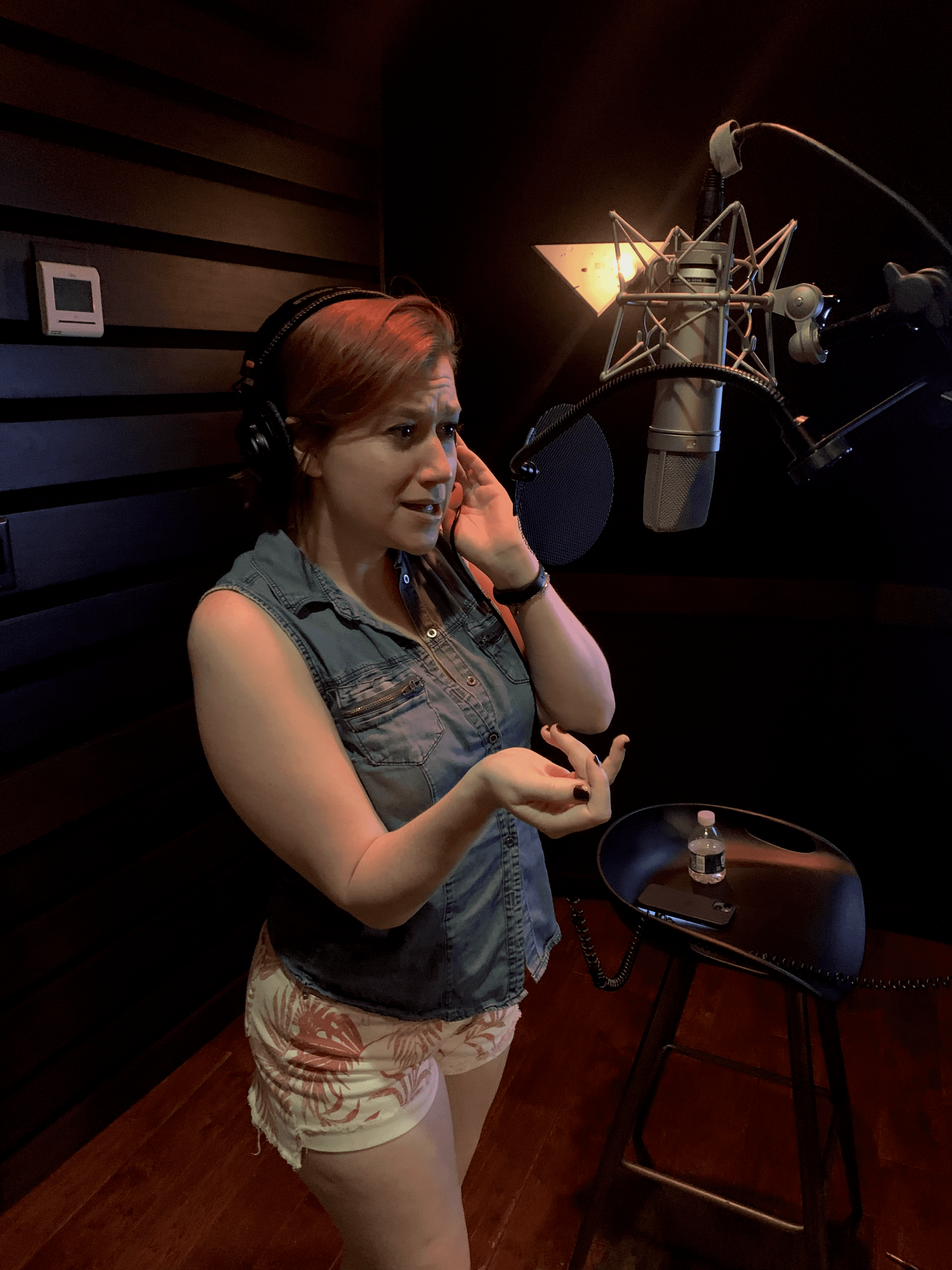 Host listening back to a take in the booth