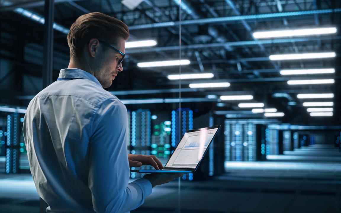 A computer keyboard with a sky background