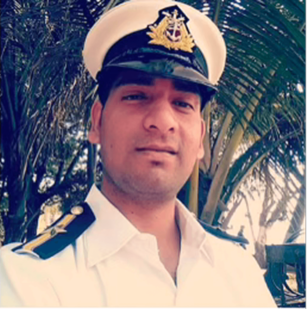 a person sitting at a table looking at the phone