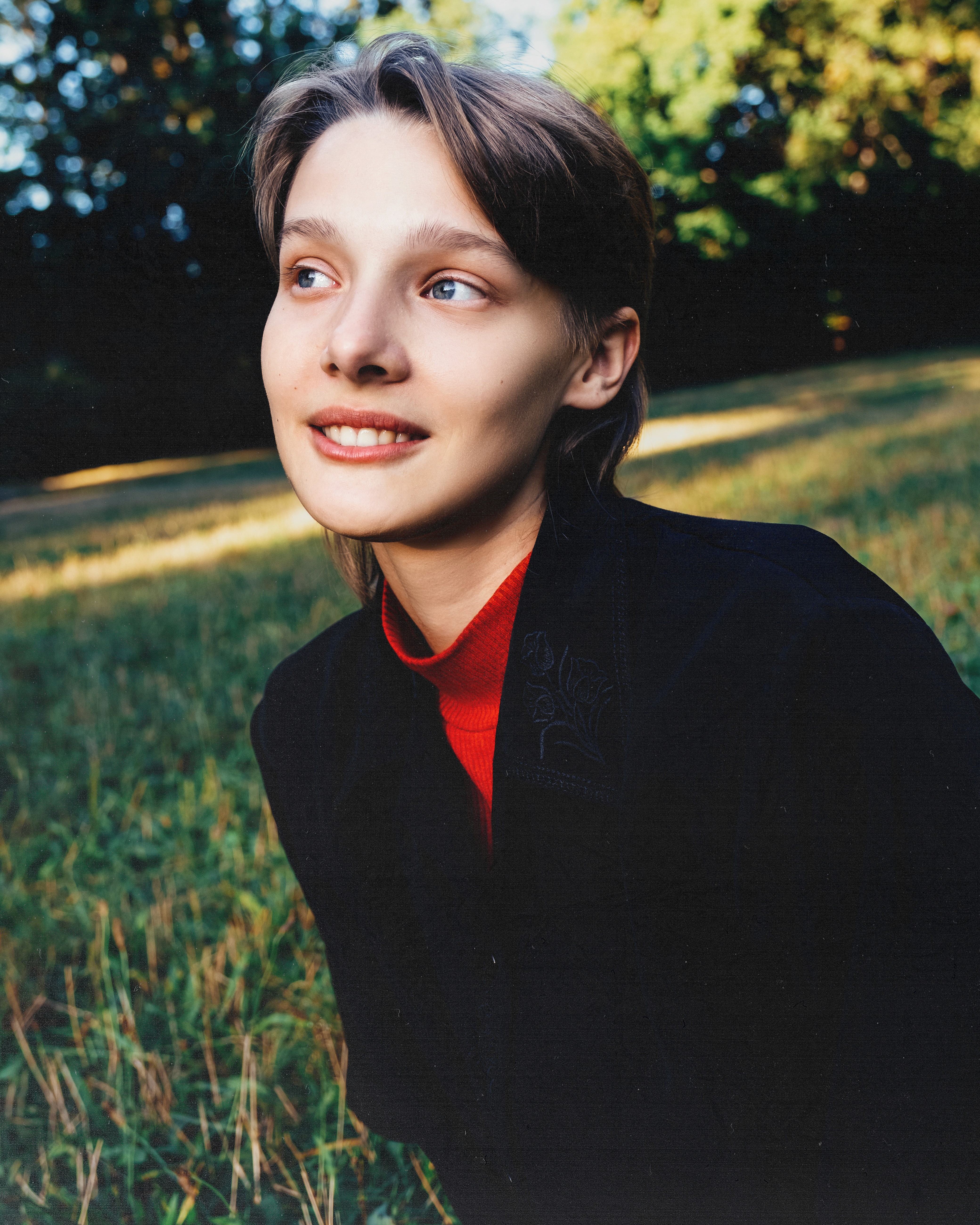 Ewa – Red Persona - portrait in a field with warm sunlight.