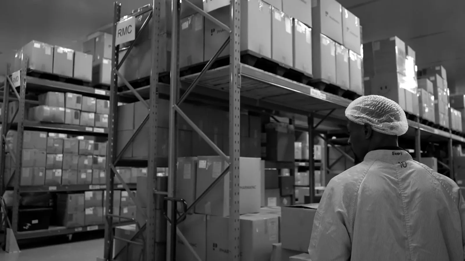 Inside the facility where Sēkret is made: the building from above, the warehouse and a cleanroom corridor, in black and white