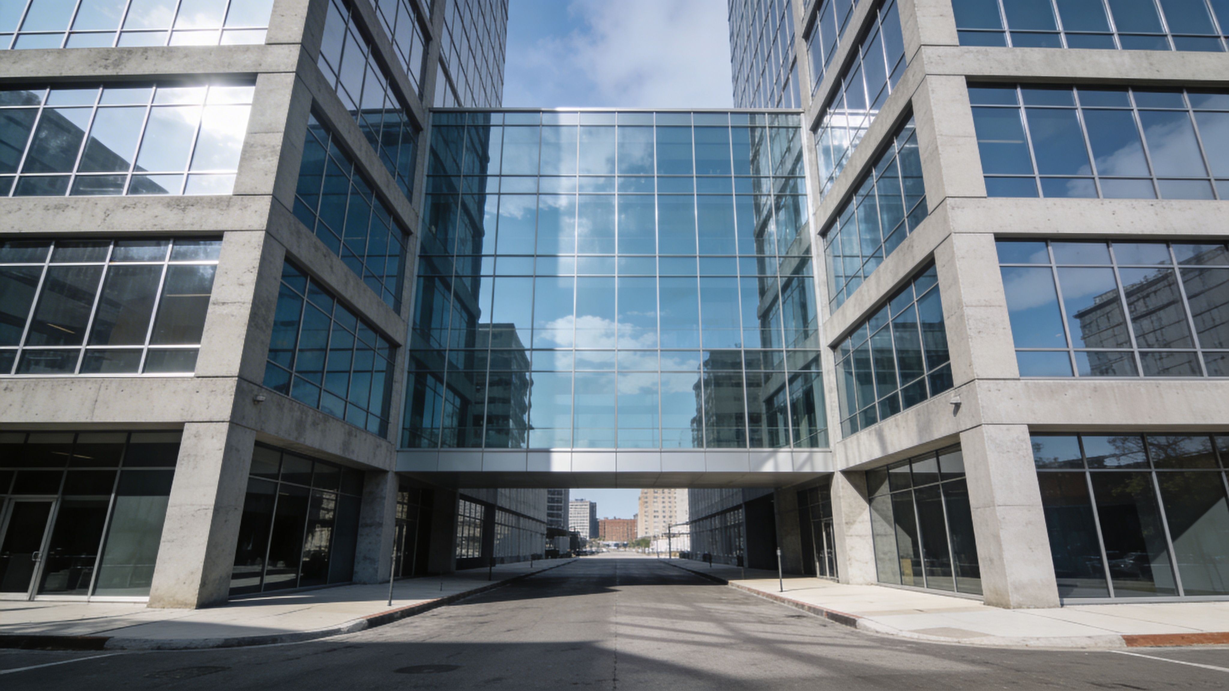 Contemporary office building exterior with glass façade and skybridge connecting two structures
