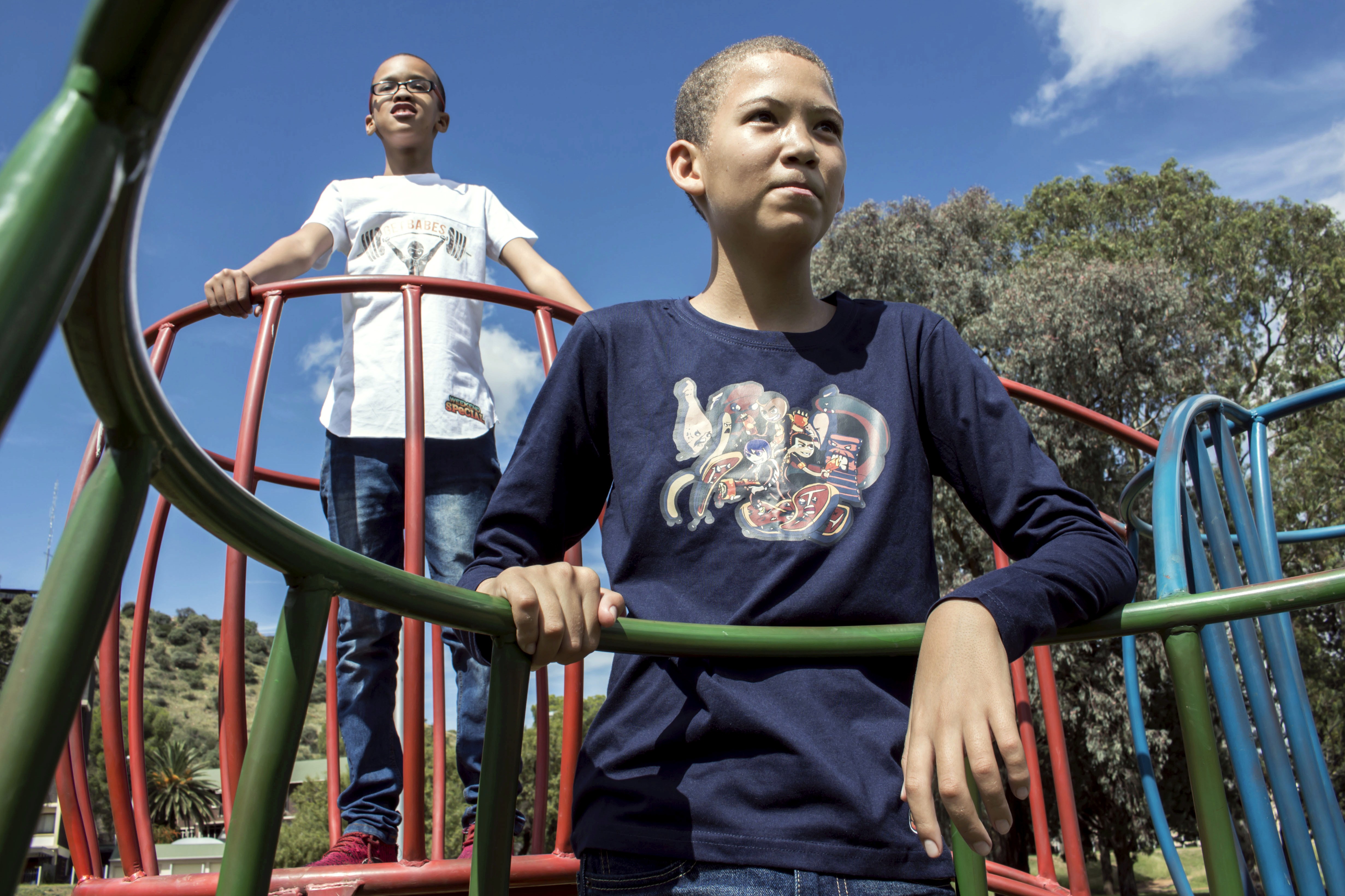 Boys on a jungle gym whaile wearing KN Studios merchandise