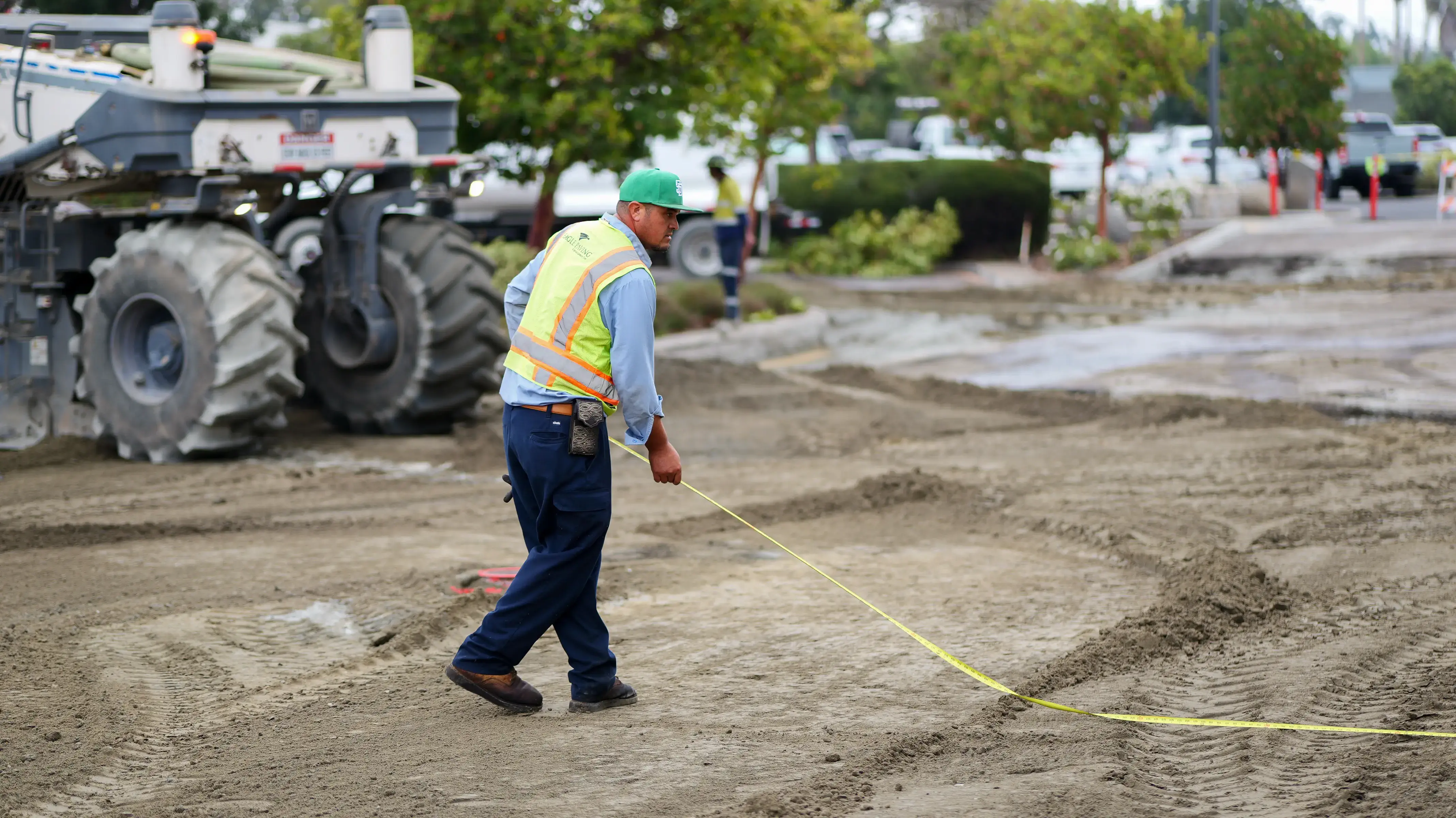 Pulverizer operator using a measuring tape to measure project