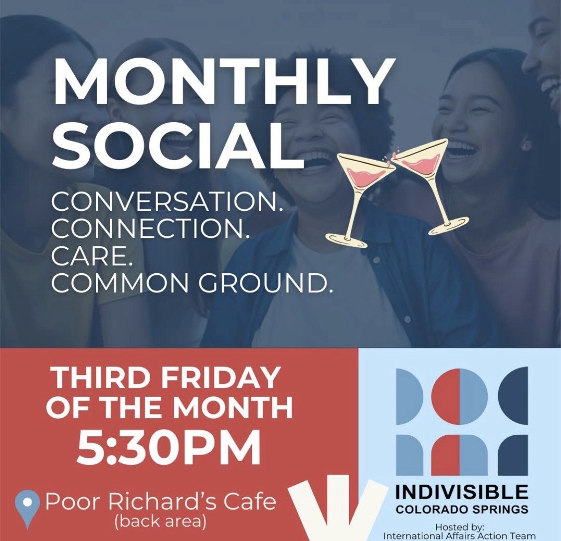 Credit: Trish Kantor. A protester with a backpack and American flag stands in front of a crowd.