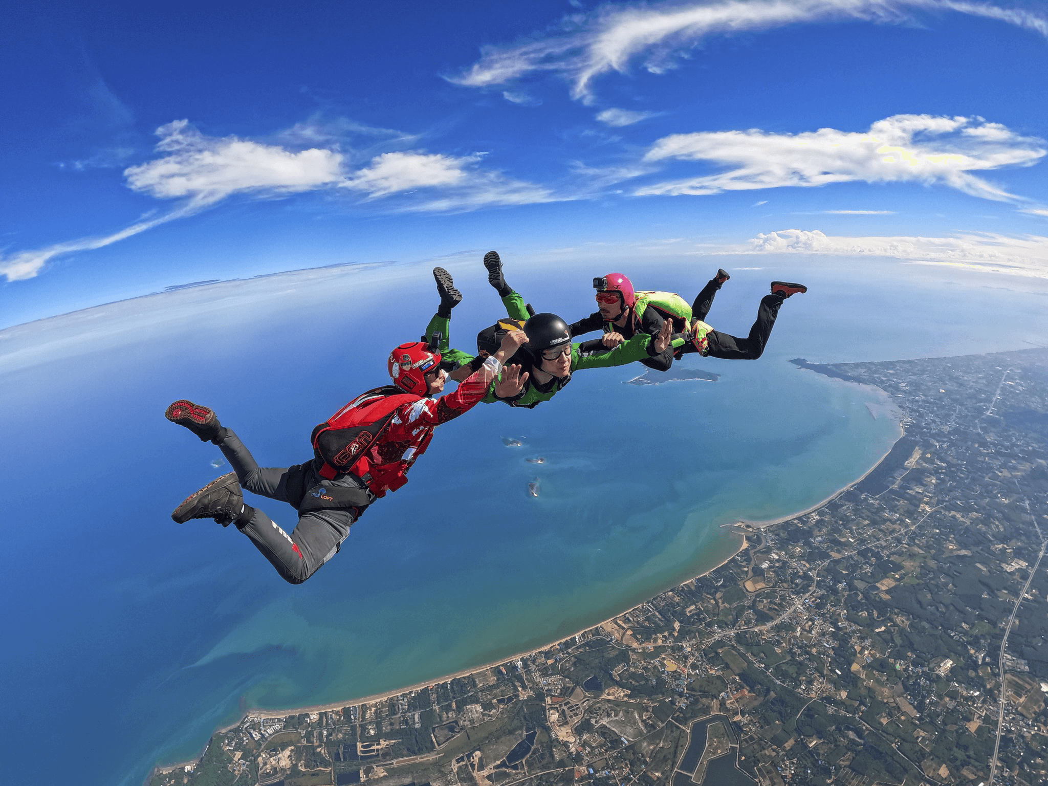AFF student in freefall with instructors holding on