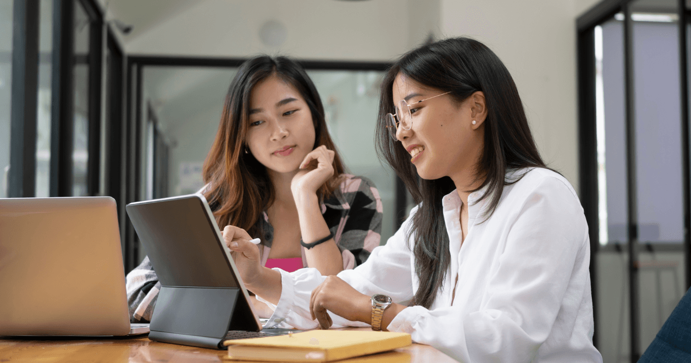 A man and a woman looking at a model of a skeleton