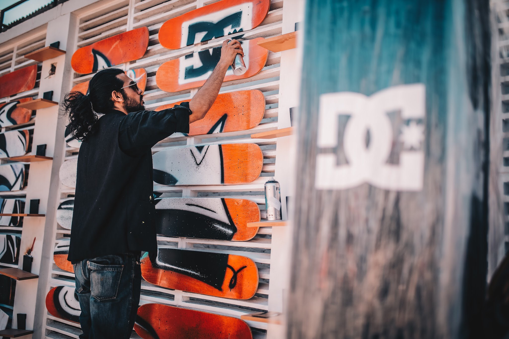 Graffiti artist from Studio atman painting mural using spray can