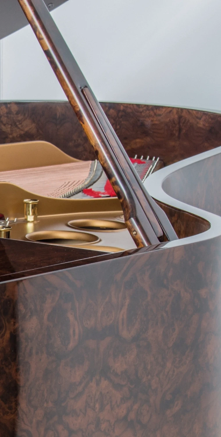 Detailed view of the piano’s open lid, revealing the beautifully restored interior and golden harp.