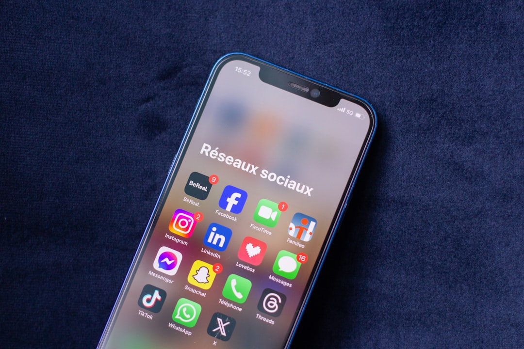 A close up of a cell phone on a blue surface