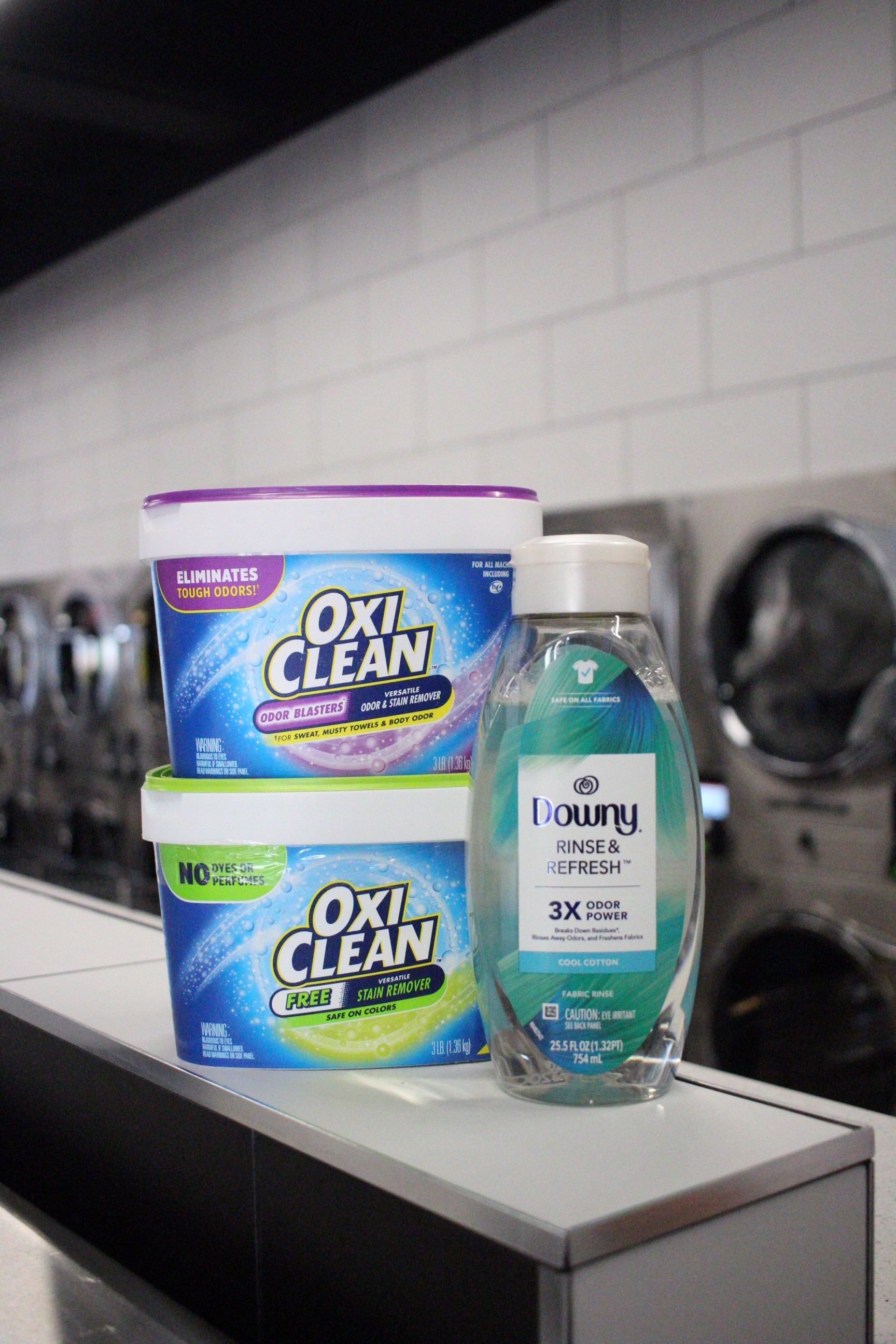 Laundry detergents displayed in a laundromat, showing upselling opportunities that contribute to laundromat profitability.