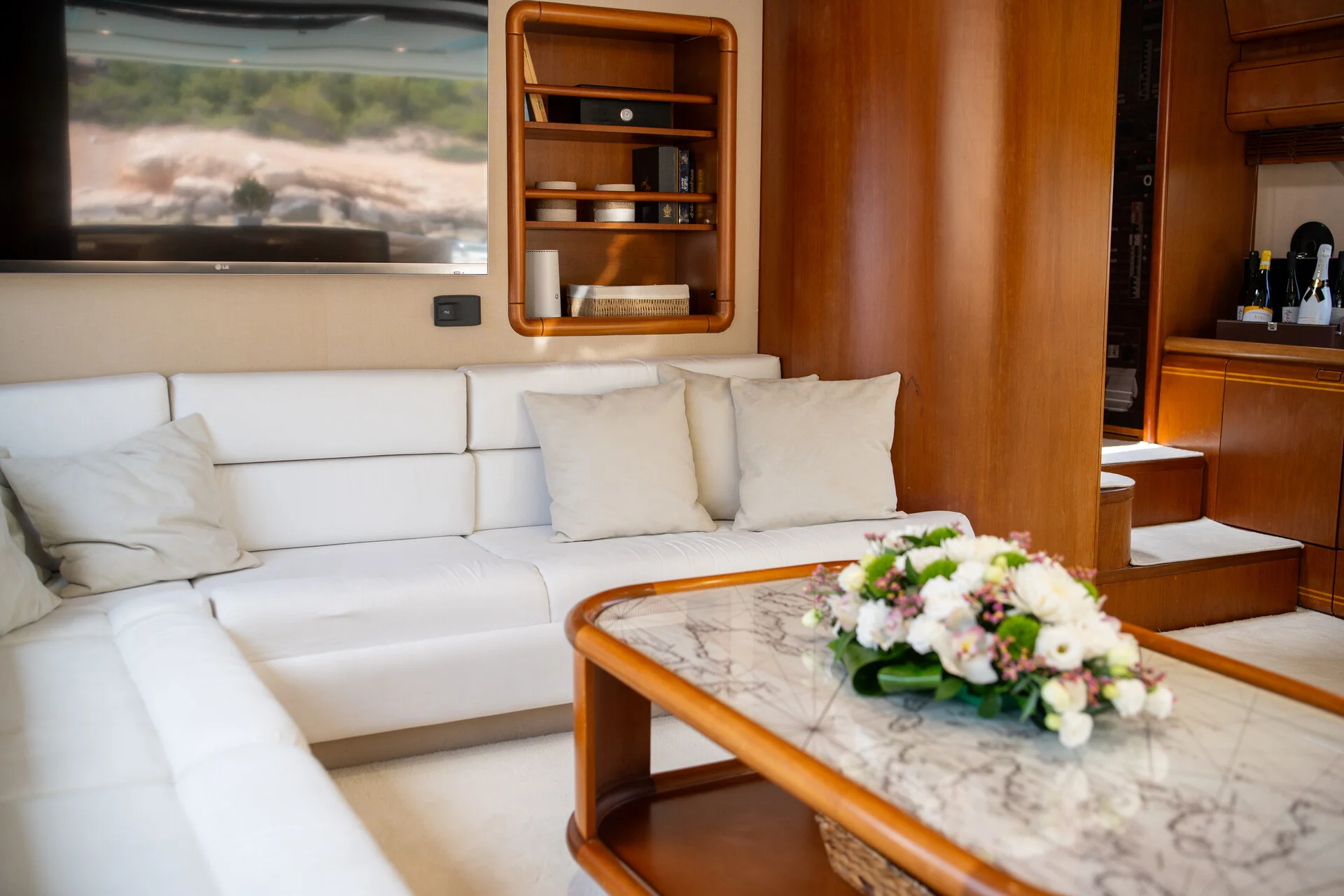White Rock 36 speedboat with captain at helm cruising calm blue waters near Paros coastline with hills in background.