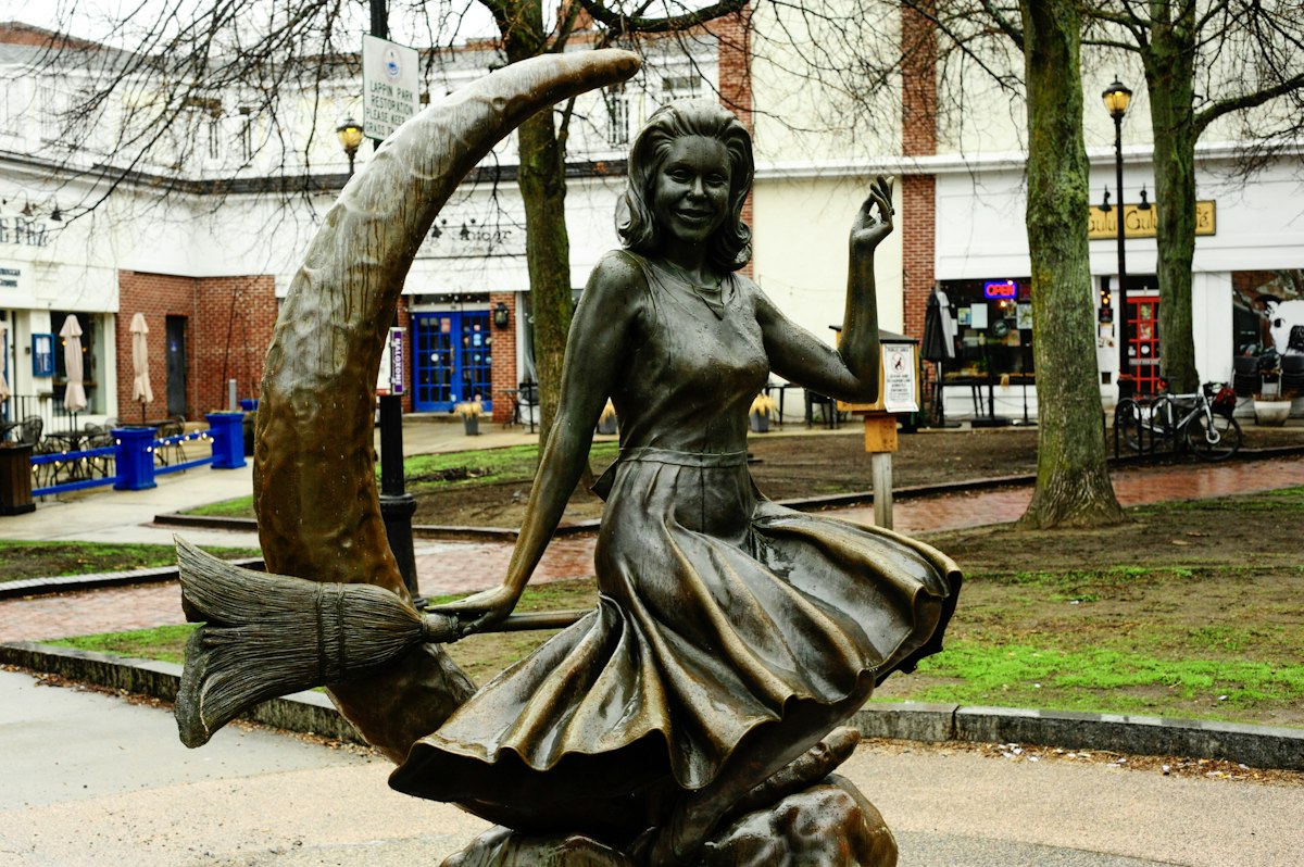 Bronze statue of a witch on a crescent moon on Salem's Essex Street pedestrian mall