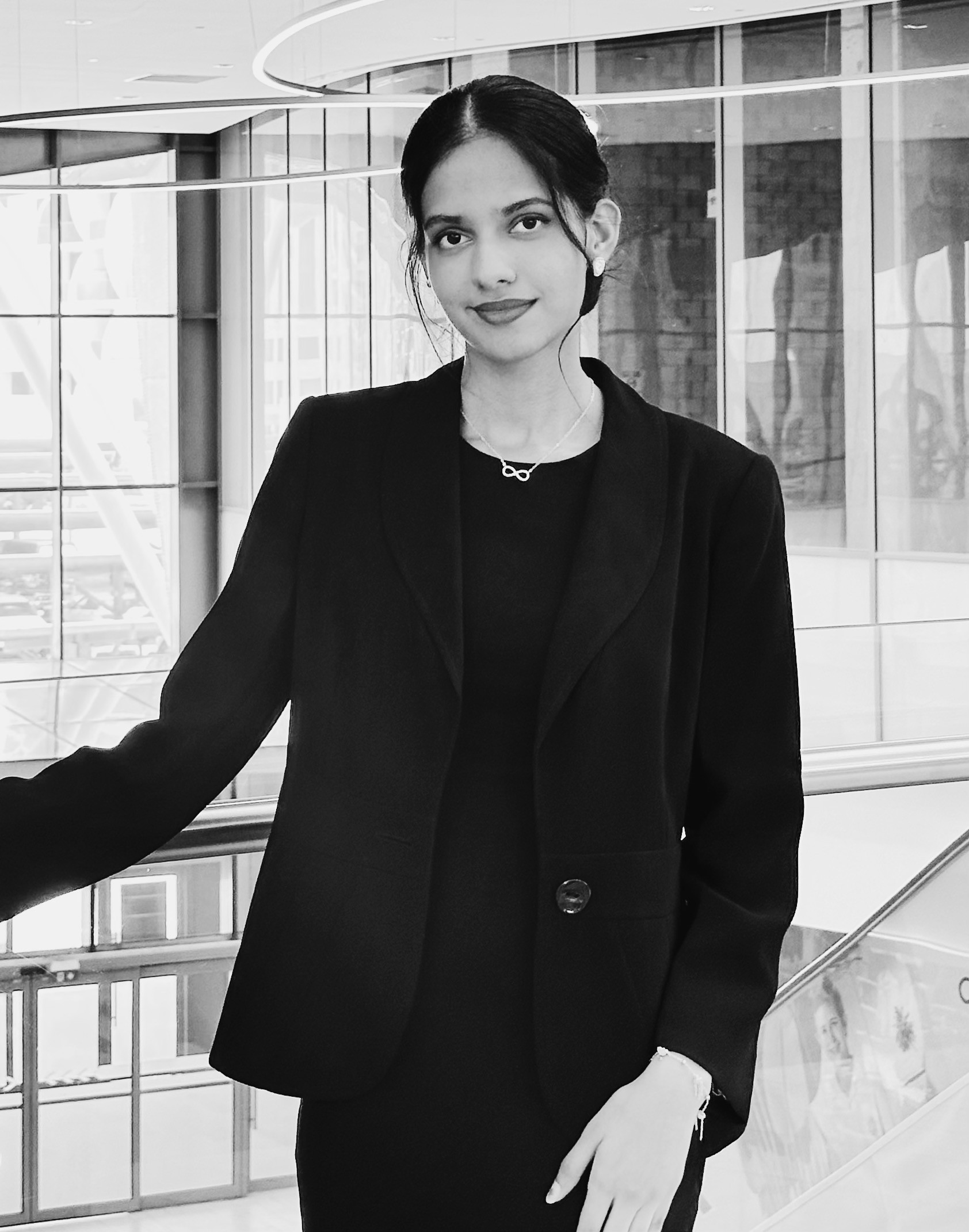 Man in a suit with arms crossed against orange background