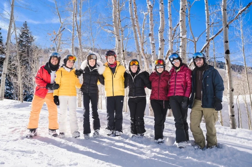 Group of friends posing in the snow during an Aspen ski trip photo session